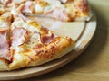 baked and sliced Ã¢â¬â¹Ã¢â¬â¹pizza with cheese, ham and sauce